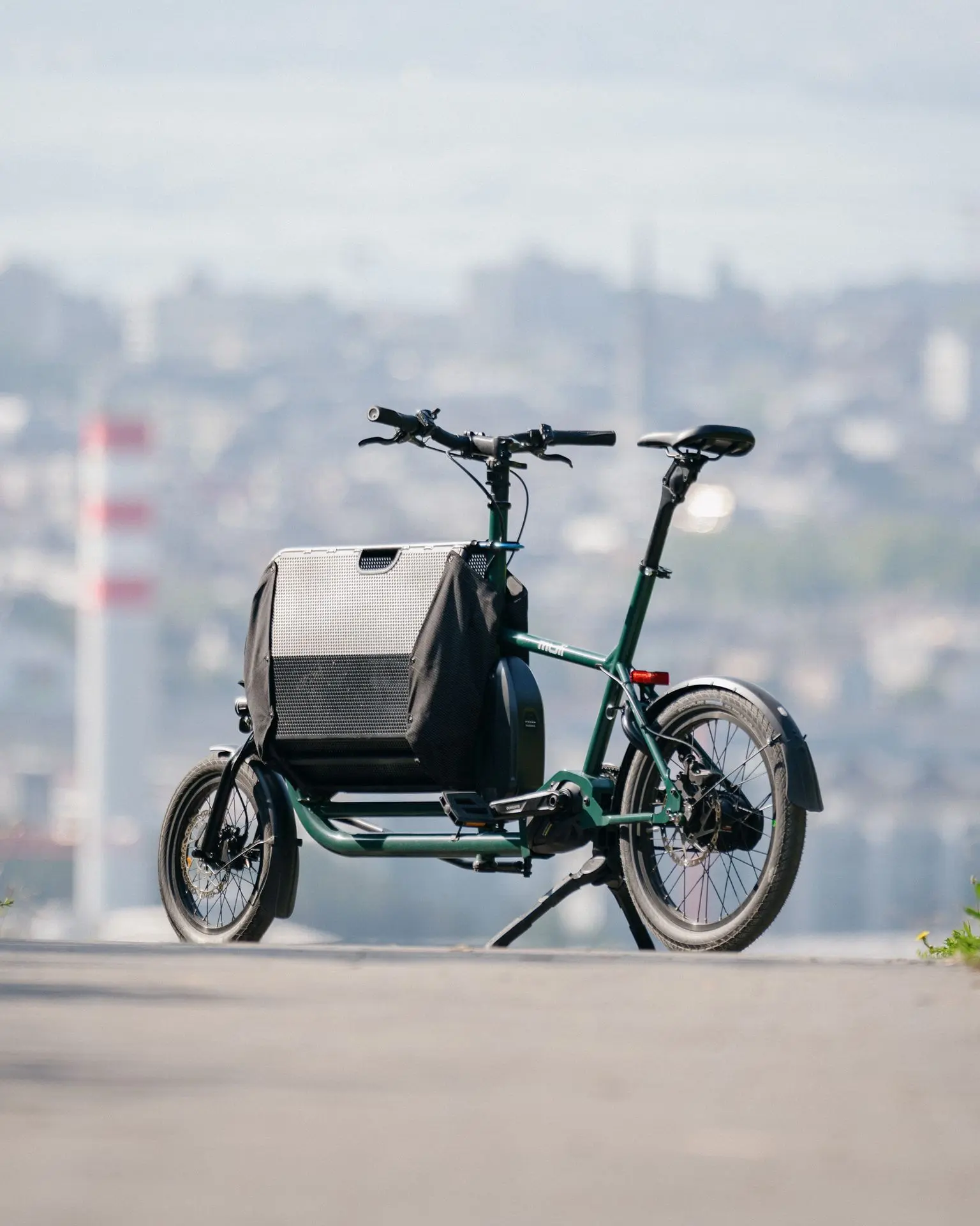 MULI Motor ST Pro: noch mehr Power, noch mehr Qualität – für alle, die mehr wollen. MULI Motor ST Pro von schräg hinten, urbaner Hintergrund – das leistungsstärkere Modell für anspruchsvolle Fahrten.